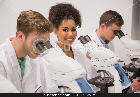To use this stock image in your creative project, please select the size you need over to the right and click the "Add to Cart" button.
Your downloaded image will come with the Cutcaster watermark removed so don’t worry about the watermark you see on this page. Medical students working with microscope stock photo, Medical students working with microscope at the university by Wavebreak Media