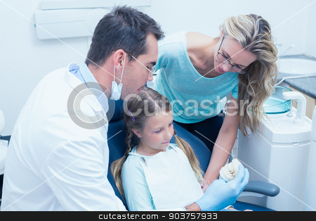 To use this stock image in your creative project, please select the size you need over to the right and click the "Add to Cart" button.
Your downloaded image will come with the Cutcaster watermark removed so don’t worry about the watermark you see on this page. Dentist with assistant teaching girl how to brush teeth stock photo, Male dentist with assistant teaching girl how to brush teeth by Wavebreak Media