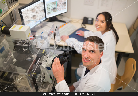 To use this stock image in your creative project, please select the size you need over to the right and click the "Add to Cart" button.
Your downloaded image will come with the Cutcaster watermark removed so don’t worry about the watermark you see on this page. Biochemistry students using large microscope and computer stock photo, Biochemistry students using large microscope and computer at the university by Wavebreak Media
