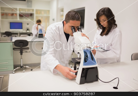 To use this stock image in your creative project, please select the size you need over to the right and click the "Add to Cart" button.
Your downloaded image will come with the Cutcaster watermark removed so don’t worry about the watermark you see on this page. Medical students working with microscope stock photo, Medical students working with microscope at the university by Wavebreak Media