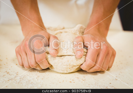 To use this stock image in your creative project, please select the size you need over to the right and click the "Add to Cart" button.
Your downloaded image will come with the Cutcaster watermark removed so don’t worry about the watermark you see on this page. Baker kneading dough at a counter stock photo, Baker kneading dough at a counter in a commercial kitchen by Wavebreak Media