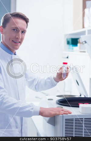 To use this stock image in your creative project, please select the size you need over to the right and click the "Add to Cart" button.
Your downloaded image will come with the Cutcaster watermark removed so don’t worry about the watermark you see on this page. Smiling chemist holding a test tube looking at camera stock photo, Smiling chemist holding a test tube looking at camera in laboratory by Wavebreak Media