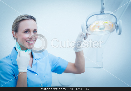 To use this stock image in your creative project, please select the size you need over to the right and click the "Add to Cart" button.
Your downloaded image will come with the Cutcaster watermark removed so don’t worry about the watermark you see on this page. Smiling female dentist adjusting light stock photo, Portrait of smiling female dentist adjusting light by Wavebreak Media