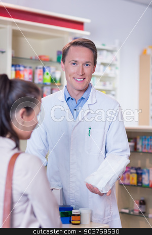 To use this stock image in your creative project, please select the size you need over to the right and click the "Add to Cart" button.
Your downloaded image will come with the Cutcaster watermark removed so don’t worry about the watermark you see on this page. Smiling pharmacist holding a paper bag looking at camera stock photo, Smiling pharmacist holding a paper bag looking at camera in the pharmacy by Wavebreak Media
