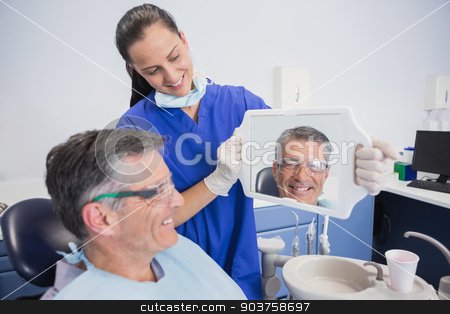 To use this stock image in your creative project, please select the size you need over to the right and click the "Add to Cart" button.
Your downloaded image will come with the Cutcaster watermark removed so don’t worry about the watermark you see on this page. Smiling dentist showing teeth of her patient with a mirror stock photo, Smiling dentist showing teeth of her patient with a mirror in dental clinic by Wavebreak Media