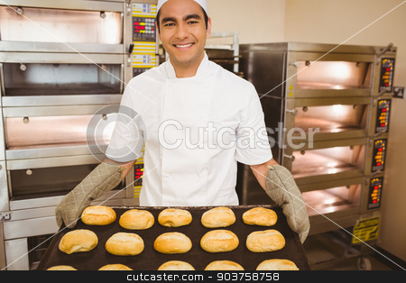 To use this stock image in your creative project, please select the size you need over to the right and click the "Add to Cart" button.
Your downloaded image will come with the Cutcaster watermark removed so don’t worry about the watermark you see on this page. Baker smiling at camera holding tray of rolls stock photo, Baker smiling at camera holding tray of rolls in a commercial kitchen by Wavebreak Media