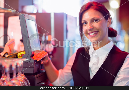 To use this stock image in your creative project, please select the size you need over to the right and click the "Add to Cart" button.
Your downloaded image will come with the Cutcaster watermark removed so don’t worry about the watermark you see on this page. Happy barmaid using touchscreen till stock photo, Happy barmaid using touchscreen till in a bar by Wavebreak Media
