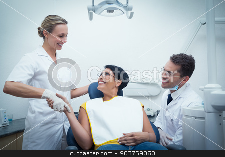 To use this stock image in your creative project, please select the size you need over to the right and click the "Add to Cart" button.
Your downloaded image will come with the Cutcaster watermark removed so don’t worry about the watermark you see on this page. Male dentist with assistant shaking hands with woman stock photo, Male dentist with assistant shaking hands with woman in the dentists chair by Wavebreak Media