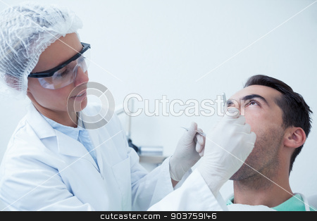 To use this stock image in your creative project, please select the size you need over to the right and click the "Add to Cart" button.
Your downloaded image will come with the Cutcaster watermark removed so don’t worry about the watermark you see on this page. Female dentist examining mans teeth stock photo, Female dentist examining mans teeth in the dentists chair by Wavebreak Media