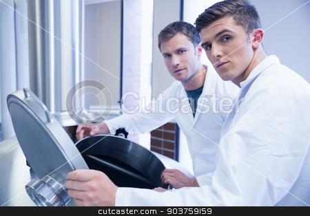 To use this stock image in your creative project, please select the size you need over to the right and click the "Add to Cart" button.
Your downloaded image will come with the Cutcaster watermark removed so don’t worry about the watermark you see on this page. Two scientists opening the lid and looking at the camera stock photo, Two scientists opening the lid and looking at the camera in the factory by Wavebreak Media