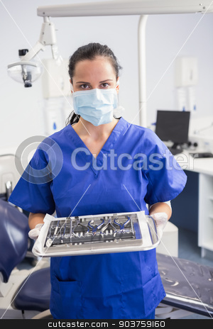 To use this stock image in your creative project, please select the size you need over to the right and click the "Add to Cart" button.
Your downloaded image will come with the Cutcaster watermark removed so don’t worry about the watermark you see on this page. Portrait of a dentist with surgical mask and holding tray stock photo, Portrait of a dentist with surgical mask and holding tray in dental clinic by Wavebreak Media