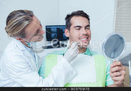To use this stock image in your creative project, please select the size you need over to the right and click the "Add to Cart" button.
Your downloaded image will come with the Cutcaster watermark removed so don’t worry about the watermark you see on this page. Female dentist examining mans teeth stock photo, Female dentist examining mans teeth in the dentists chair by Wavebreak Media