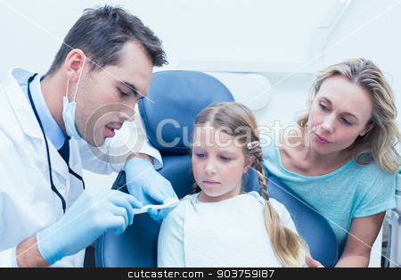 To use this stock image in your creative project, please select the size you need over to the right and click the "Add to Cart" button.
Your downloaded image will come with the Cutcaster watermark removed so don’t worry about the watermark you see on this page. Dentist with assistant teaching girl how to brush teeth stock photo, Male dentist with assistant teaching girl how to brush teeth by Wavebreak Media