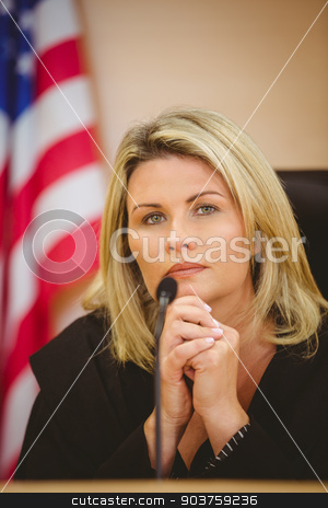 To use this stock image in your creative project, please select the size you need over to the right and click the "Add to Cart" button.
Your downloaded image will come with the Cutcaster watermark removed so don’t worry about the watermark you see on this page. Portrait of a serious judge with american flag behind her stock photo, Portrait of a serious judge with american flag behind her in the court room by Wavebreak Media