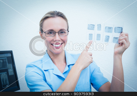 To use this stock image in your creative project, please select the size you need over to the right and click the "Add to Cart" button.
Your downloaded image will come with the Cutcaster watermark removed so don’t worry about the watermark you see on this page. Smiling female dentist pointing at x-ray stock photo, Portrait of smiling young female dentist pointing at x-ray by Wavebreak Media