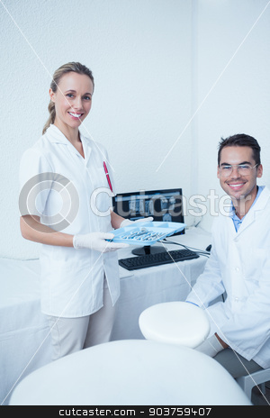 To use this stock image in your creative project, please select the size you need over to the right and click the "Add to Cart" button.
Your downloaded image will come with the Cutcaster watermark removed so don’t worry about the watermark you see on this page. Portrait of smiling dentists with computer monitor stock photo, Portrait of smiling male and female dentists with computer monitor by Wavebreak Media
