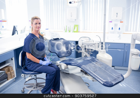 To use this stock image in your creative project, please select the size you need over to the right and click the "Add to Cart" button.
Your downloaded image will come with the Cutcaster watermark removed so don’t worry about the watermark you see on this page. Dentist smiling at camera beside chair stock photo, Dentist smiling at camera beside chair at the dental clinic by Wavebreak Media