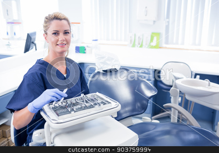To use this stock image in your creative project, please select the size you need over to the right and click the "Add to Cart" button.
Your downloaded image will come with the Cutcaster watermark removed so don’t worry about the watermark you see on this page. Dentist sitting with tray of tools smiling at camera stock photo, Dentist sitting with tray of tools smiling at camera at the dental clinic by Wavebreak Media