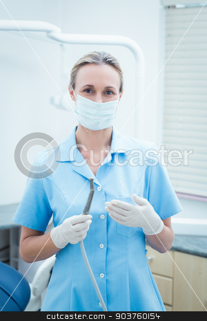 To use this stock image in your creative project, please select the size you need over to the right and click the "Add to Cart" button.
Your downloaded image will come with the Cutcaster watermark removed so don’t worry about the watermark you see on this page. Female dentist in surgical mask holding dental tool stock photo, Portrait of female dentist in surgical mask holding dental tool by Wavebreak Media