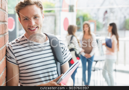 To use this stock image in your creative project, please select the size you need over to the right and click the "Add to Cart" button.
Your downloaded image will come with the Cutcaster watermark removed so don’t worry about the watermark you see on this page. Handsome student smiling and holding notepads stock photo, Handsome student smiling and holding notepads at the university by Wavebreak Media