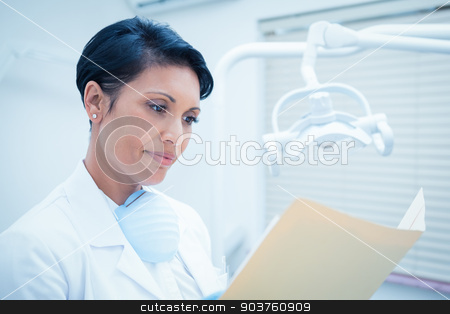 To use this stock image in your creative project, please select the size you need over to the right and click the "Add to Cart" button.
Your downloaded image will come with the Cutcaster watermark removed so don’t worry about the watermark you see on this page. Female dentist reading reports stock photo, Serious female dentist reading reports by Wavebreak Media