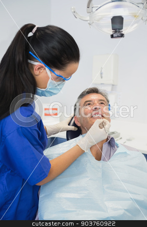 To use this stock image in your creative project, please select the size you need over to the right and click the "Add to Cart" button.
Your downloaded image will come with the Cutcaster watermark removed so don’t worry about the watermark you see on this page. Dentist wearing surgical mask and safety glasses stock photo, Dentist wearing surgical mask and safety glasses examining a patient by Wavebreak Media
