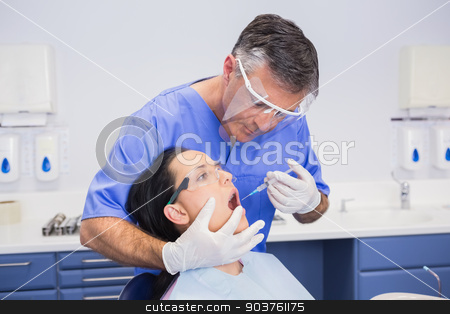 To use this stock image in your creative project, please select the size you need over to the right and click the "Add to Cart" button.
Your downloaded image will come with the Cutcaster watermark removed so don’t worry about the watermark you see on this page. Dentist wearing face shield and doing injection to his patient stock photo, Dentist wearing face shield and doing injection to his patient in dental clinic by Wavebreak Media