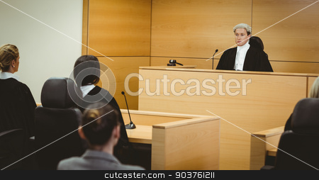 To use this stock image in your creative project, please select the size you need over to the right and click the "Add to Cart" button.
Your downloaded image will come with the Cutcaster watermark removed so don’t worry about the watermark you see on this page. Unsmiling judge wearing wig with american flag behind him stock photo, Unsmiling judge wearing wig with american flag behind him in the court room by Wavebreak Media