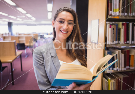 To use this stock image in your creative project, please select the size you need over to the right and click the "Add to Cart" button.
Your downloaded image will come with the Cutcaster watermark removed so don’t worry about the watermark you see on this page. Pretty student reading book in library stock photo, Pretty student reading book in library at the university by Wavebreak Media