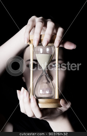 To use this stock image in your creative project, please select the size you need over to the right and click the "Add to Cart" button.
Your downloaded image will come with the Cutcaster watermark removed so don’t worry about the watermark you see on this page. Time concept stock photo, young beautiful girl holding an hourglass in front on a black background by Suchota