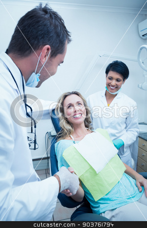 To use this stock image in your creative project, please select the size you need over to the right and click the "Add to Cart" button.
Your downloaded image will come with the Cutcaster watermark removed so don’t worry about the watermark you see on this page. Dentist with assistant shaking hands with woman stock photo, Male dentist with assistant shaking hands with woman in the dentists chair by Wavebreak Media