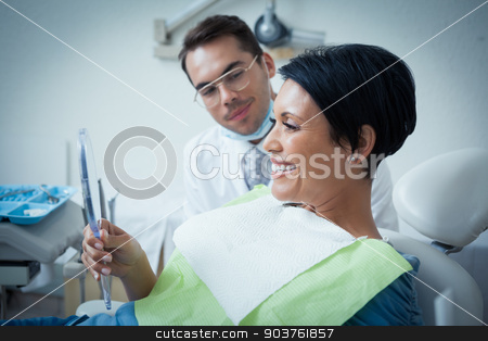 To use this stock image in your creative project, please select the size you need over to the right and click the "Add to Cart" button.
Your downloaded image will come with the Cutcaster watermark removed so don’t worry about the watermark you see on this page. Side view of smiling female patient with dentist stock photo, Side view of smiling female patient with dentist in the dentists chair by Wavebreak Media
