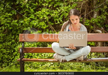To use this stock image in your creative project, please select the size you need over to the right and click the "Add to Cart" button.
Your downloaded image will come with the Cutcaster watermark removed so don’t worry about the watermark you see on this page. Student sitting on bench listening music and using laptop stock photo, Student sitting on bench listening to music and using laptop and wearing headphones by Wavebreak Media