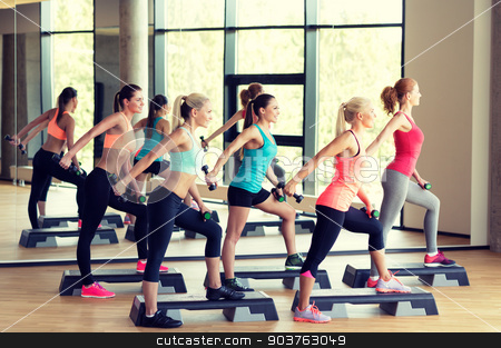 To use this stock image in your creative project, please select the size you need over to the right and click the "Add to Cart" button.
Your downloaded image will come with the Cutcaster watermark removed so don’t worry about the watermark you see on this page. group of women with dumbbells and steppers stock photo, fitness, sport, training, gym and lifestyle concept - group of women working out with dumbbells and steppers in gym by Syda Productions