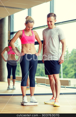 To use this stock image in your creative project, please select the size you need over to the right and click the "Add to Cart" button.
Your downloaded image will come with the Cutcaster watermark removed so don’t worry about the watermark you see on this page. smiling man and woman with scales in gym stock photo, sport, fitness, lifestyle and people concept - smiling man and woman with scales in gym by Syda Productions