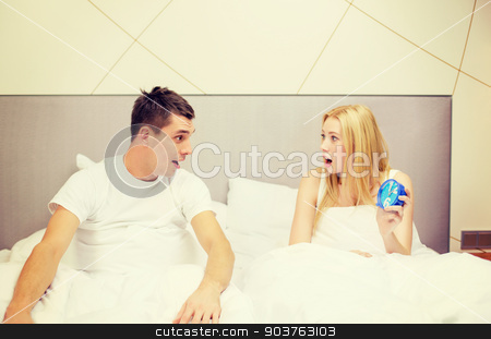 To use this stock image in your creative project, please select the size you need over to the right and click the "Add to Cart" button.
Your downloaded image will come with the Cutcaster watermark removed so don’t worry about the watermark you see on this page. surprised couple with clock in bed stock photo, hotel, travel, relationships and happiness concept - surprised couple with clock in bed by Syda Productions