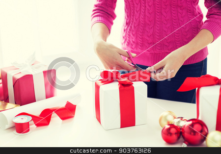 To use this stock image in your creative project, please select the size you need over to the right and click the "Add to Cart" button.
Your downloaded image will come with the Cutcaster watermark removed so don’t worry about the watermark you see on this page. close up of woman decorating christmas presents stock photo, holidays, people and celebration concept - close up of woman decorating christmas presents by Syda Productions