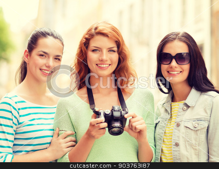 To use this stock image in your creative project, please select the size you need over to the right and click the "Add to Cart" button.
Your downloaded image will come with the Cutcaster watermark removed so don’t worry about the watermark you see on this page. smiling teenage girls with camera stock photo, tourism, travel, leisure, holidays and friendship concept - smiling teenage girls with camera outdoors by Syda Productions