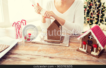 To use this stock image in your creative project, please select the size you need over to the right and click the "Add to Cart" button.
Your downloaded image will come with the Cutcaster watermark removed so don’t worry about the watermark you see on this page. close up of woman making gingerbread houses stock photo, cooking, people, christmas and decoration concept - happy woman making gingerbread houses at home by Syda Productions