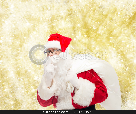 To use this stock image in your creative project, please select the size you need over to the right and click the "Add to Cart" button.
Your downloaded image will come with the Cutcaster watermark removed so don’t worry about the watermark you see on this page. man in costume of santa claus with bag stock photo, christmas, holidays and people concept - man in costume of santa claus with bag making hush gesture over yellow lights background by Syda Productions