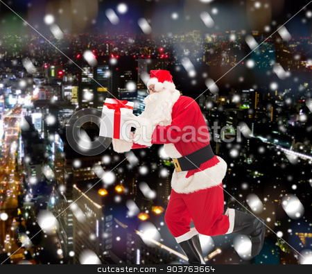 To use this stock image in your creative project, please select the size you need over to the right and click the "Add to Cart" button.
Your downloaded image will come with the Cutcaster watermark removed so don’t worry about the watermark you see on this page. man in costume of santa claus with gift box stock photo, christmas, holidays and people concept - man in costume of santa claus running with gift box over snowy night city background by Syda Productions