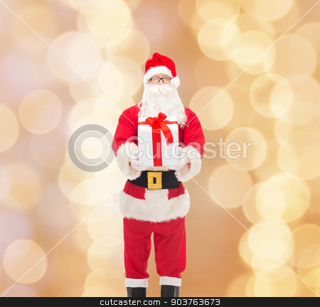 To use this stock image in your creative project, please select the size you need over to the right and click the "Add to Cart" button.
Your downloaded image will come with the Cutcaster watermark removed so don’t worry about the watermark you see on this page. man in costume of santa claus with gift box stock photo, christmas, holidays and people concept - man in costume of santa claus with gift box over beige lights background by Syda Productions