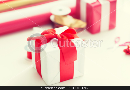 To use this stock image in your creative project, please select the size you need over to the right and click the "Add to Cart" button.
Your downloaded image will come with the Cutcaster watermark removed so don’t worry about the watermark you see on this page. close up of christmas presents stock photo, holidays and celebration concept - close up of christmas presents, decoration paper, ribbons and scissors by Syda Productions