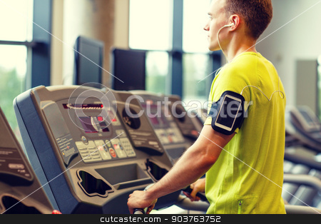 To use this stock image in your creative project, please select the size you need over to the right and click the "Add to Cart" button.
Your downloaded image will come with the Cutcaster watermark removed so don’t worry about the watermark you see on this page. man with smartphone exercising on treadmill in gym stock photo, sport, fitness, lifestyle, technology and people concept - man with smartphone and earphones exercising on treadmill in gym by Syda Productions