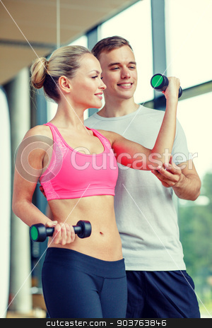 To use this stock image in your creative project, please select the size you need over to the right and click the "Add to Cart" button.
Your downloaded image will come with the Cutcaster watermark removed so don’t worry about the watermark you see on this page. smiling young woman with personal trainer in gym stock photo, fitness, sport, exercising and diet concept - smiling young woman and personal trainer with dumbbells in gym by Syda Productions