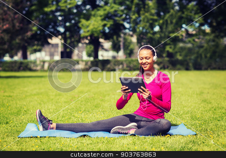 To use this stock image in your creative project, please select the size you need over to the right and click the "Add to Cart" button.
Your downloaded image will come with the Cutcaster watermark removed so don’t worry about the watermark you see on this page. smiling woman with tablet pc outdoors stock photo, fitness, park, technology and sport concept - smiling african american woman with tablet pc computer and headphones on mat outdoors by Syda Productions