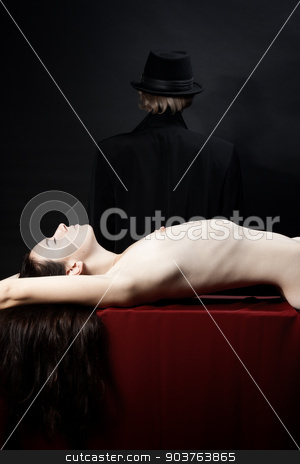 To use this stock image in your creative project, please select the size you need over to the right and click the "Add to Cart" button.
Your downloaded image will come with the Cutcaster watermark removed so don’t worry about the watermark you see on this page. victim of a vampire stock photo, beautiful young nude girl lying on the red fabric. In the background is the person in a black hat and cloak by Suchota