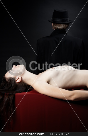 To use this stock image in your creative project, please select the size you need over to the right and click the "Add to Cart" button.
Your downloaded image will come with the Cutcaster watermark removed so don’t worry about the watermark you see on this page. victim of a vampire stock photo, beautiful young nude girl lying on the red fabric. In the background is the person in a black hat and cloak by Suchota