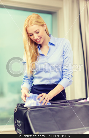 To use this stock image in your creative project, please select the size you need over to the right and click the "Add to Cart" button.
Your downloaded image will come with the Cutcaster watermark removed so don’t worry about the watermark you see on this page. businesswoman packing things in suitcase stock photo, business, technology, internet and hotel concept - happy businesswoman packing things in suitcase in hotel room by Syda Productions