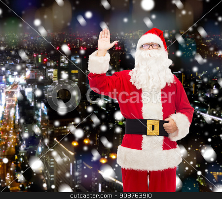 To use this stock image in your creative project, please select the size you need over to the right and click the "Add to Cart" button.
Your downloaded image will come with the Cutcaster watermark removed so don’t worry about the watermark you see on this page. man in costume of santa claus stock photo, christmas, holidays, gesture and people concept - man in costume of santa claus waving hand over snowy night city background by Syda Productions